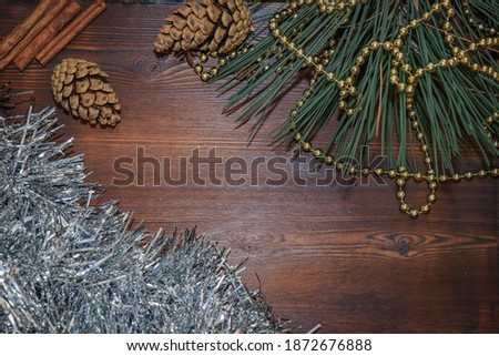 New year's background. Christmas decorations. Christmas toys and shiny beads. Wooden background. Holiday atmosphere. Pine branch