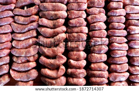 Linguiça. Raw sausage on a Brazilian barbecue skewer