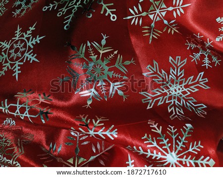 Christmas silver snowflakes on a red background.