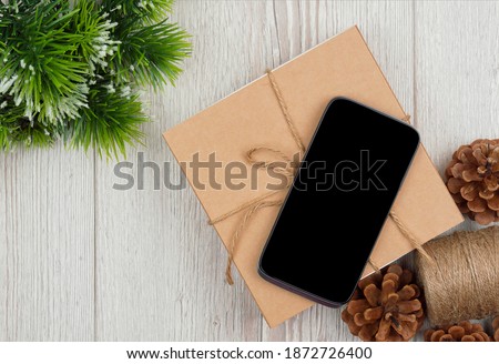 Christmas shopping online. Mockup , blank screen smartphone on wood  background for Christmas and New Year concept, Flat lay. top view,copy space .