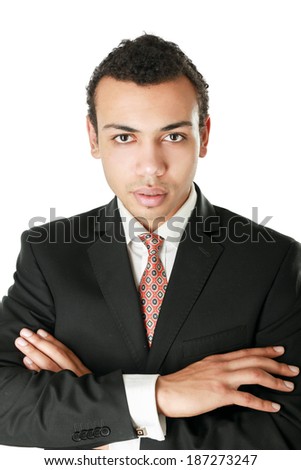 Handsome young business man standing with folded arms on white background