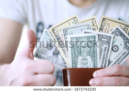 Cash money in a large pile as a finance background. Paper money close up. Top view.
