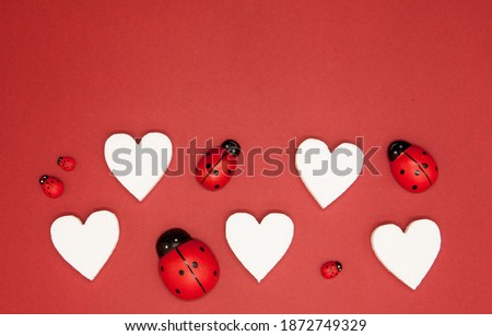Valentine's day white background for congratulations. Background with place for text. On a beautiful black heart a pair of ladybugs