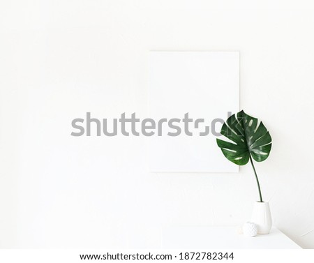 mock up poster frame on coffee table with decorations on white wall background