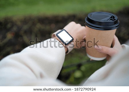 Smart watch and coffee in the hands of a girl mockup