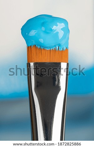 Single paint brush with blue paint macro