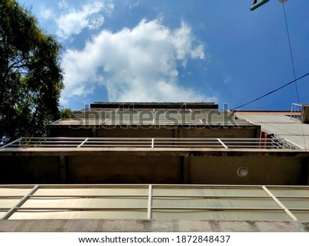 Wide shot picture of modern building with blue sky in the back