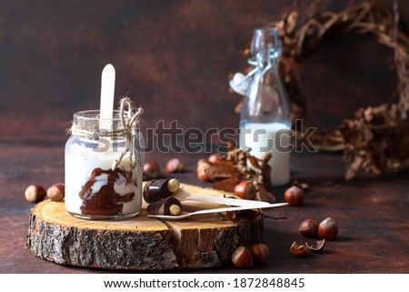 homemade instant chocolate for drinking, ported on a wooden spoon, selective focus, dark background