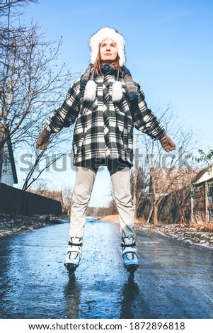 Ice skating girl. Figure skating. Winter leisure. Winter asphalt icing