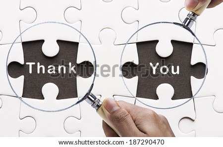 Magnifying glass searching missing puzzle peace "Thank You" 