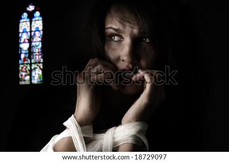 woman in fear with patch around her arms an a church windows on back Royalty-Free Stock Photo #18729097