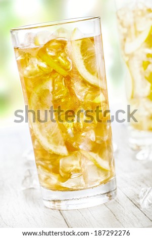 Lemon ice tea on summer background