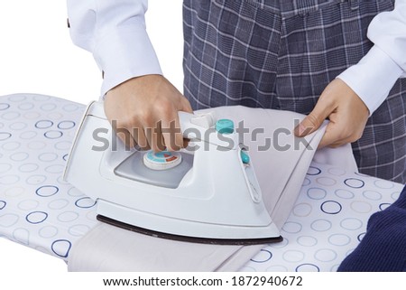 
Man in elegant clothes or suit ironing pants on ironing board. Isolated on white background.