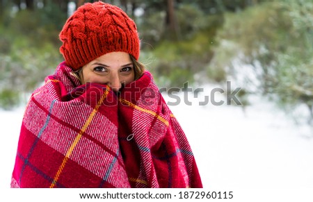 Caucasian woman standing in snowy forest