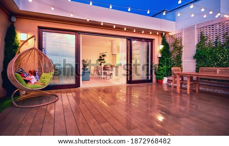 cozy rooftop patio with sliding doors in the evening after the rain