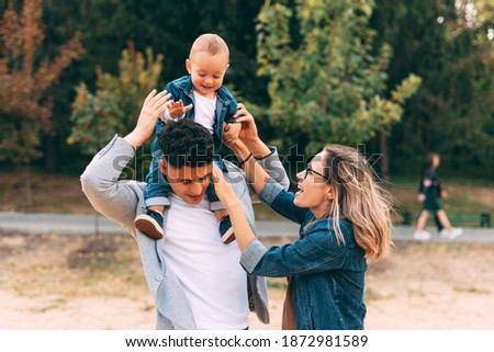 A picture of a family in park playing together