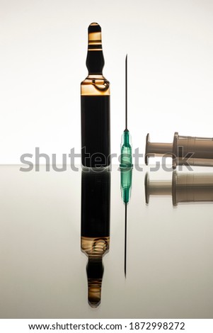close-up medical glass ampoule bottle pandemic, epidemic, infectious or other diseases treatment drug serum syringe