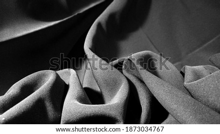 Black layered and wavy fabric, taken from the side, is perfect for textiles or fashion design elements