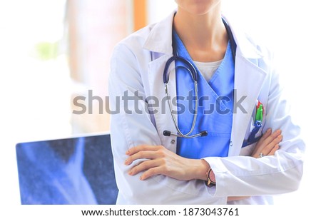 Woman doctor standing with medical stethoscope at hospital