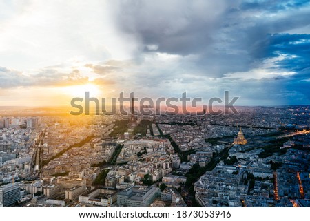 Panoramic aerial view of Paris city skyline and Eiffel Tower during the sunset. Time slice photography from afternoon to night.