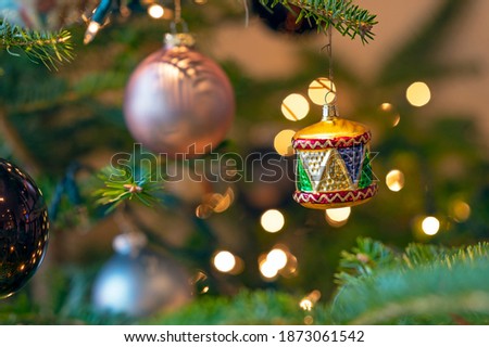 Christmas tree decorations, baubles and lights on a Christmas tree, celebrate the festive season. Selective focus on individual baubles.