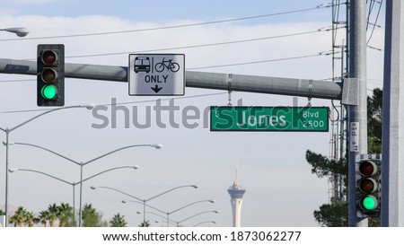 Street name sign of S. Jones Blvd. at the intersection of W. Sahara Ave. in Las Vegas, Nevada, USA. A traffic sign indicating right lane restriction for buses and bicycles shares the same pole.