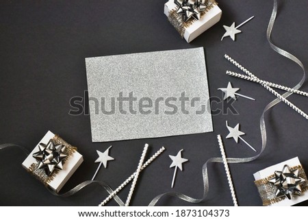 Happy birthday card. Birthday party paper straws, gift boxes and candles on gray background. Happy birthday background. Party decoration. Design concept. Postcard. Copy space, flat lay. 
