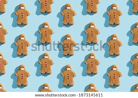 Pandemic seamless pattern. Conceptual pastry design. Festive bakery illustration. Decorated gingerbread icing man in protective mask isolated on blue pastel.