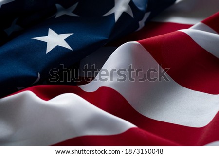 Wavy American flag fluttering in the wind, close-up details. USA symbol of freedom