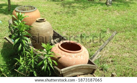 Pottery jar used for storing water in ancient times. Nowadays used to plant trees to decorate gardens Thailand
