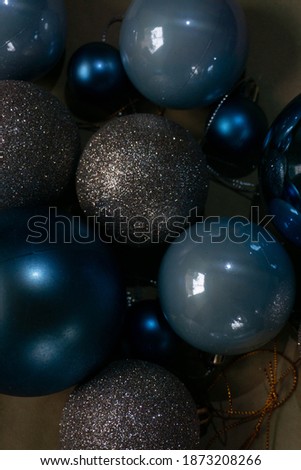 
Christmas decorations in the form of a ball, blue, blue and silver shiny color, with a focus on one ball, darkened