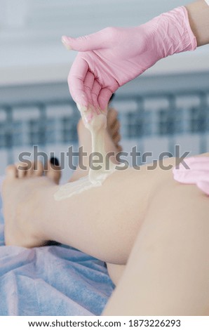Epilation procedure. Pink gloves. Large view