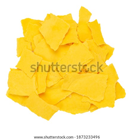 Pile of torn yellow paper isolated white background. Top view.