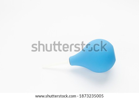 Blue enema ot syringe bulb on white background.