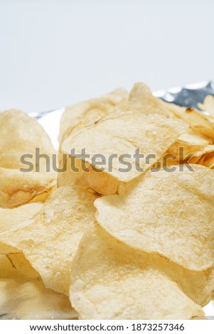 Potato chips (Potato crisps) on white background