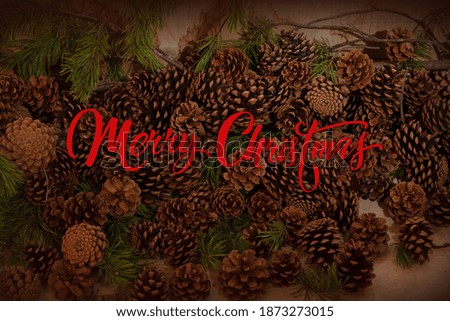 Pine cones background isolated on wooden background. Merry christmas card with cones background