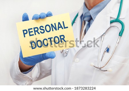 Doctor in gloves holding a sign with the text - PERSONAL DOCTOR
