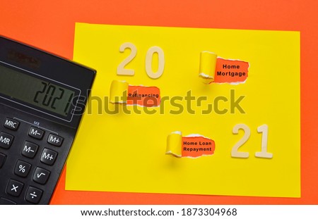 Text on colorful torn paper with Year 2021 and black calculator background. Happy New Year 2021 And Finance Concept