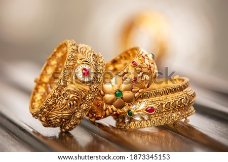 Fancy designer antique golden bracelets for woman fashion studio shot. Royalty-Free Stock Photo #1873345153