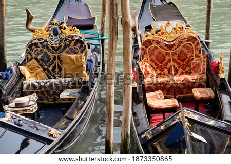 Ornate gondolas moored in the canal in Venice, Italy
