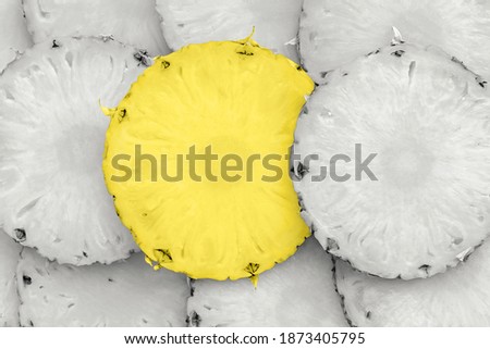 Sliced ripe pineapple pieces lay in pattern, top detailed view. Creative tropical food concept. Pantone colors of 2021 - Illuminating Yellow and Ultimate Gray 