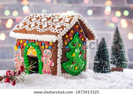 Beautiful decorated gingerbread house for New Year or Christmas celebration. Bokeh background