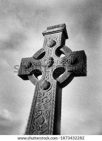 old holy cross in ireland in the background cloudy sky. This black and white picture was taken with an analog medium format camera