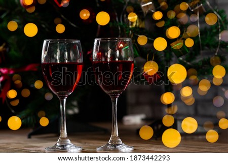 Red wine in glass on wooden bar,  blurred background.