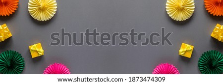Festive bright composition of paper decorations on a gray background.Birthday, wedding day, mother's day.Copy space Banner 