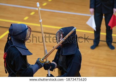 Kendo is a modern martial art of Japanese fencing with bamboo swords. Royalty-Free Stock Photo #1873475620