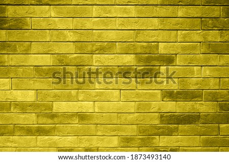 pattern of decorative yellow gray slate stone wall surface as a background. toned in illuminating and ultimate gray, trend color of the year 2021