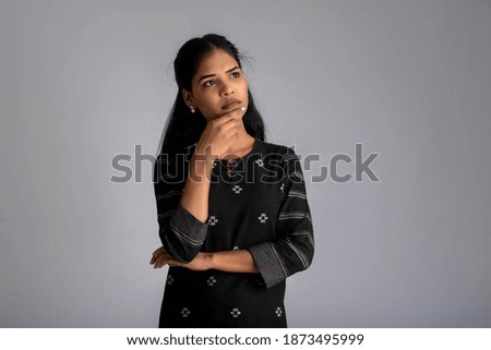 Portrait of a young girl posing on gray background