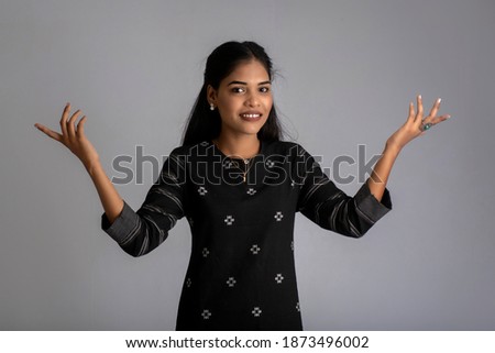 Portrait of a young girl posing on gray background