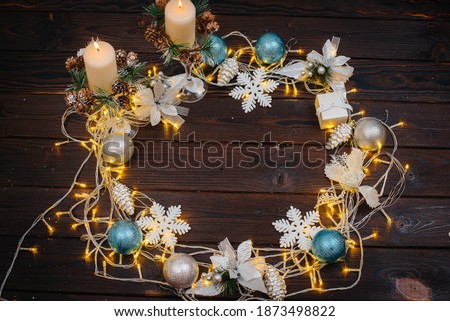 Brown Christmas background decorated with festive Christmas decor and accessories, garland. Festive new year's card